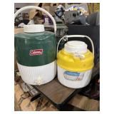 green and white Coleman 2 gallon plastic water