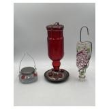 Three glass hummingbird feeders