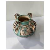 Spanish ceramic jug featuring a green, cream, and