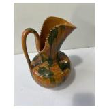 Decorative glazed pottery pitcher