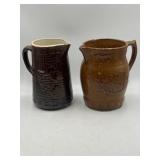 Pair of brown stoneware pitchers, likely North