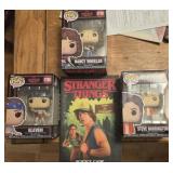 4 funkos and 1 paperback books from the Netflix