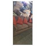 Brown sofa with 4 throw pillows