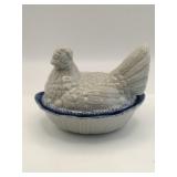 Blue and white resting hen