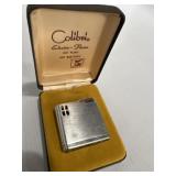 silver-tone Colibri Electro-Flame lighter in its