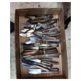 assortment of dinner knives in flat