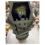 Animated Cursed Coffin features a pop-up zombie