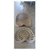 2 rusted metal tractor seats