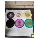 Lot of six Frisbee golf discs.