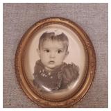 Vintage convex picture frame with old picture.