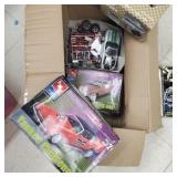 Box of model cars and parts and pieces.