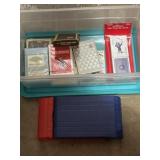 Playing cards and games in small lidded tub