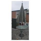 Metal base glass top patio table with umbrella