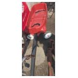 Red plastic two person radio flyer wagon