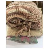 Crochet blanket, twin quilted blanket, and chair