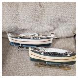 2 wooden sailboats.