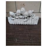 Shelf sculpture of children.
