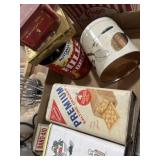 Collection of tea tins, cracker tins, and other