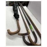 Three walking canes, and one umbrella