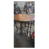Round top drop leaf table with kick out legs