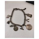 Silver charm bracelet. Marked some Sterling.