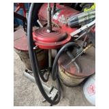 3 manual grease pumps and large caulk gun