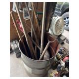 55 gallon drum full of shovels and post hole