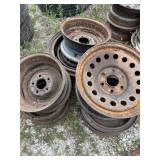 Seven vehicle rims are various sizes