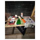 Partially knitted blanket with knitting needles,