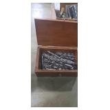 Wooden box with assortment of drill bits
