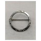 Silver round pin  marked Sterling.   060oz