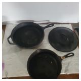 2 cast iron skillets  and 1 lid 1 lodge