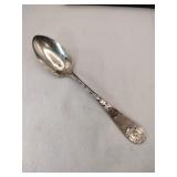 Silver flowered handle teaspoon marked Sterling.