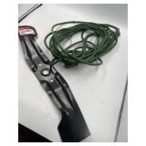 Green outdoor extension, cord and Honda mower