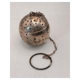 Silver Spherical teaball infuser marked Sterling.