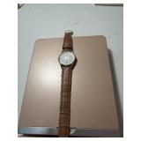 Gold toned quartz wrist watch with brown leather
