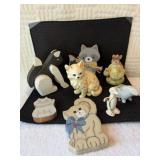 Three wooden cats, one ceramic yellow cat, one