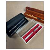 4 ballpoint pens with cases one in designer wood