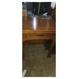 Small sewing table with singer sewing machine