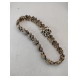 Gold tone clear Stone X bracelet marked 925.