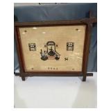 Framed cross-stitch sampler featuring