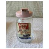 Sioux Bee Honey dispenser with pink handle.