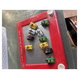 10 pull back mini toy cars and a Etch A Sketch