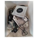 Bin of assorted GameCube and XBox game parts.