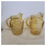 2 amber glass pitchers 9in tall
