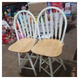 2 white and wood swivel barstools