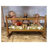 20 x 11 doll rocking bed with three dolls.