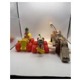 Two Snoopy pull toys and one clown pull toy. Made