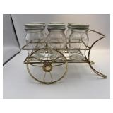 Vintage wire cart with six glass jars.