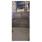 Green upholstered love seat/ hide a bed